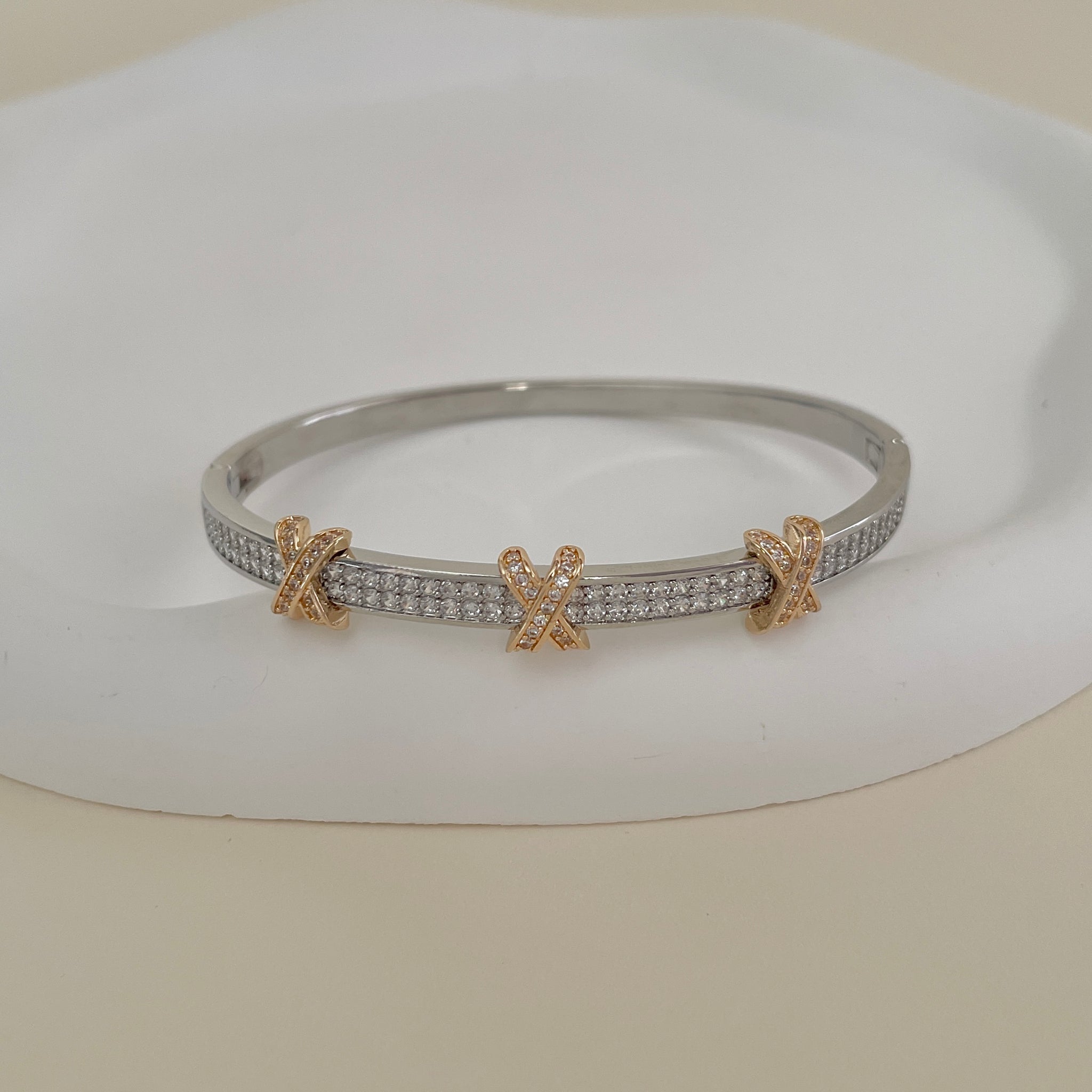 Pulseira bracelete com detalhe em x dourado e banho de ródio branco