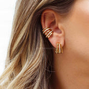 Piercing linhas lisas e cravejadas dourado